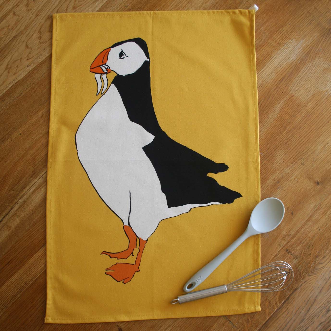 tea towel with puffin and yellow background