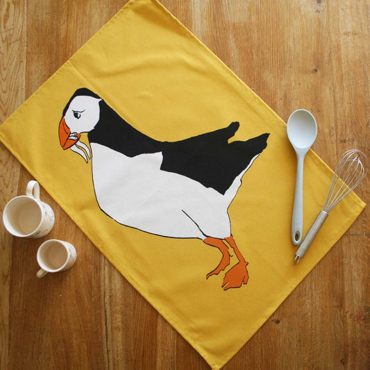 tea towel with puffin and yellow background